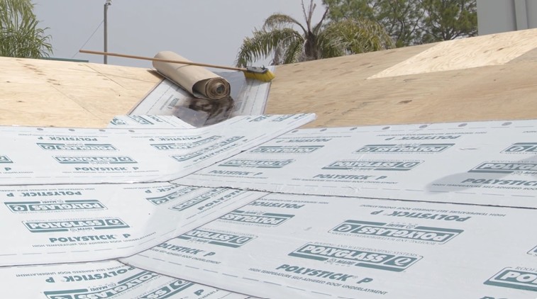 Self-adhered underlayment on a sloped plywood roof deck